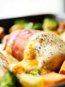 One Pan Cheesy Chicken and Vegetables. Tender chicken breasts wrapped in prosciutto, stuffed with THREE kinds of cheese, and roasted to perfection with broccoli and potatoes. Easy weeknight meal for the win! showmetheyummy.com Recipe made in partnership w/ @WisconsinCheese #WisconsinCheese #chicken
