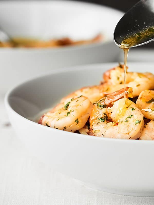 bowl of shrimp scampi drizzled with dressing 