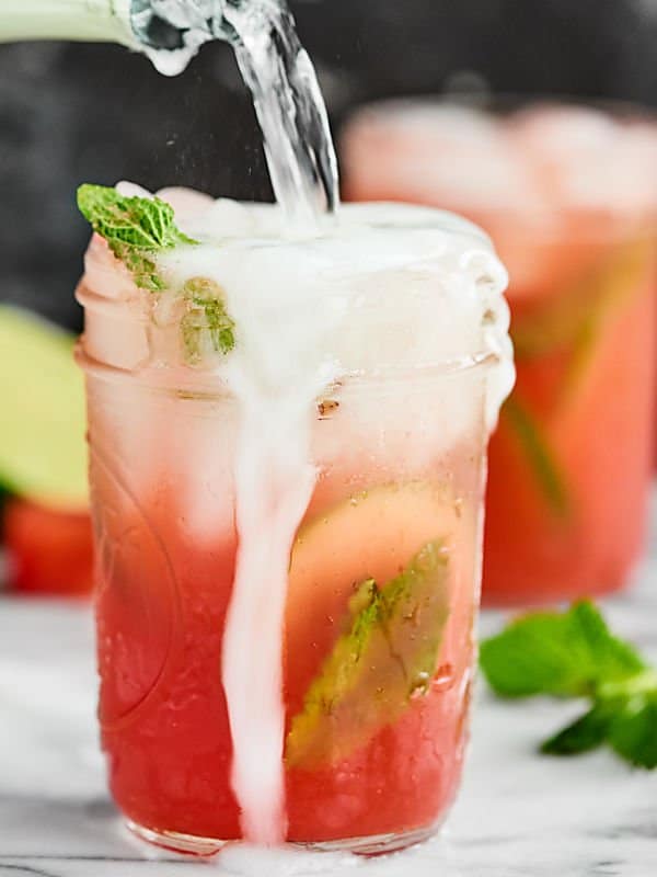 sparkling watermelon mojito in mason jar overflowing