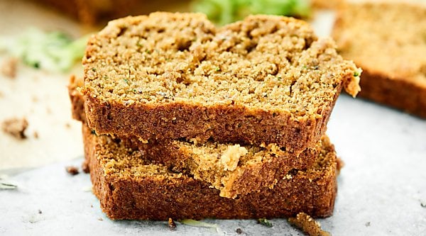 Tons of zucchini on your hands? Vegan Zucchini Bread tooooo the rescue! It's tender, it's moist, and it's loaded with cozy cinnamon, sweet brown sugar, coconut oil, and of course, plenty of zucchini! showmetheyummy.com #zucchinibread #vegan