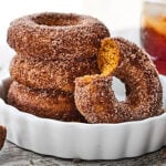 This Easy Baked Pumpkin Donuts Recipe is the perfect way to celebrate the start of fall. Tender, perfectly spiced donuts smothered in either a maple glaze or cinnamon sugar! showmetheyummy.com #bakeddonuts #pumpkindonuts