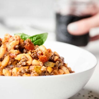 This American Goulash is full of ground beef, vegetables, spices, and macaroni pasta. A one pot wonder on the table in under 30 minutes that's perfect cold weather comfort food! showmetheyummy.com Recipe made in partnership w/ @redgoldtomatoes #HelpCrushHunger #americangoulash