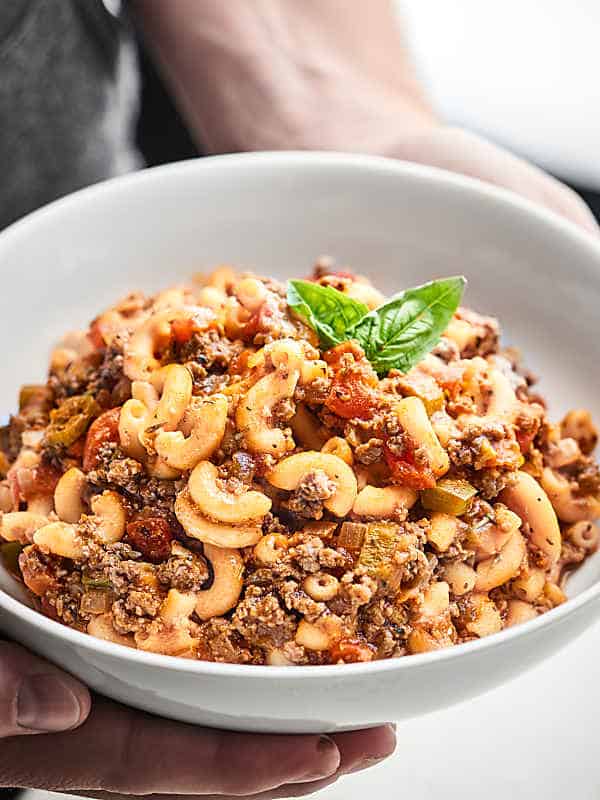 Bowl of american goulash held