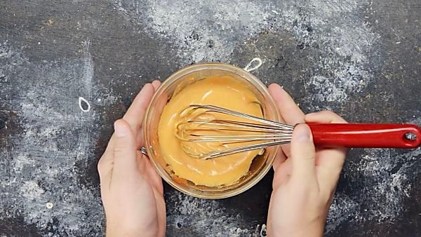 Spicy mayo in small bowl with whisk