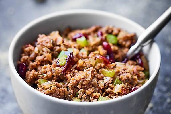 An easy gluten free stuffing, this Cornbread Dressing Recipe will surely impress! Full of italian sausage, vegetables, homemade cornbread, cranberries, spices, and more! showmetheyummy.com #cornbreaddressing #cornbreadstuffing