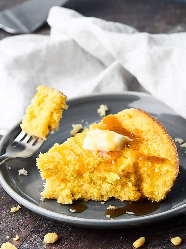 Slice of cornbread, bite taken out with fork
