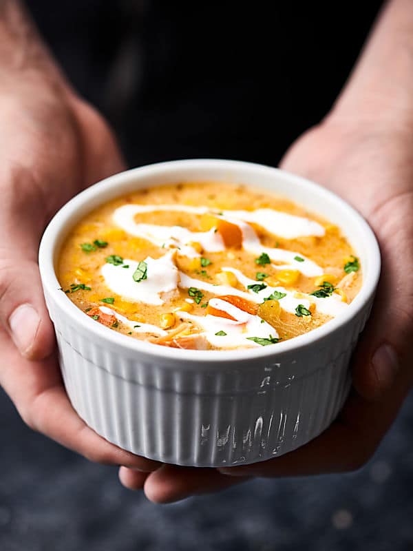 bowl of turkey corn chowder held two hands