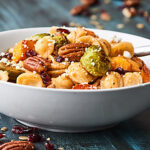 This Easy Roasted Fall Vegetable Pasta Recipe is full of roasted butternut squash and brussels sprouts, pecans, pumpkin seeds, goat cheese, and dried cranberries! showmetheyummy.com #fallpasta #roastedvegetables