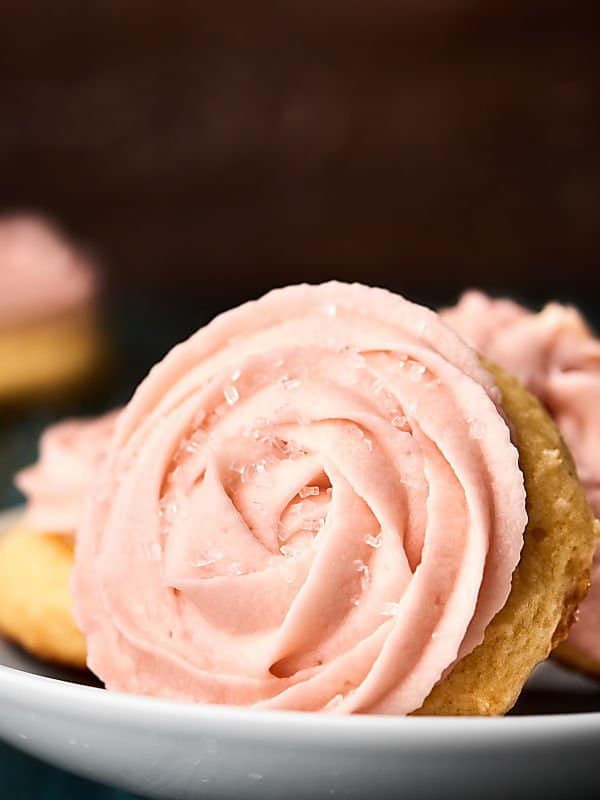 champagne sugar cookies with buttercream frosting on plate