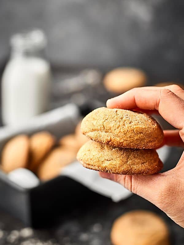 two ginger cookies stacked and held