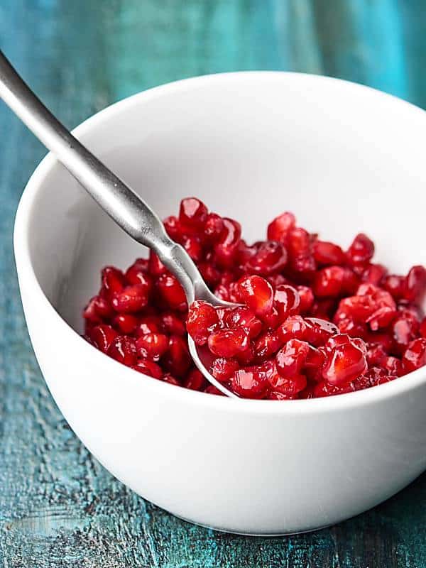 bowl of pomegranate seeds with spoon
