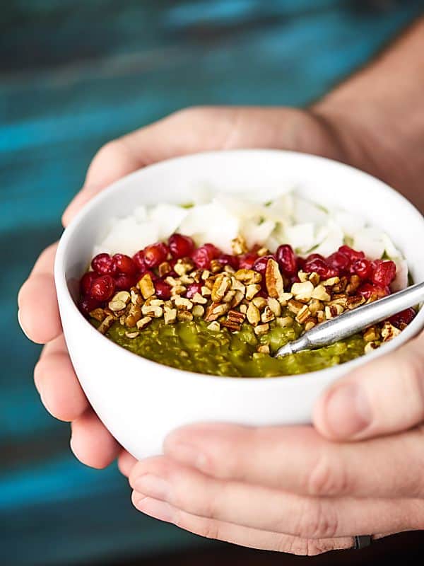 bowl of crockpot matcha oatmeal held two hands