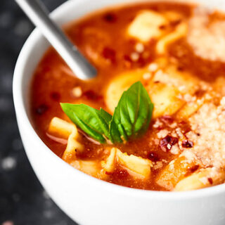 #ad A light vegetarian soup loaded with cheesy pasta, tomatoes, and spices, this Crockpot Tomato Tortellini Soup is quick to put together and is a sure crowd pleaser! showmetheyummy.com Made in partnership w/ @redgoldtomatoes #crockpotsoup #tortellinisoup