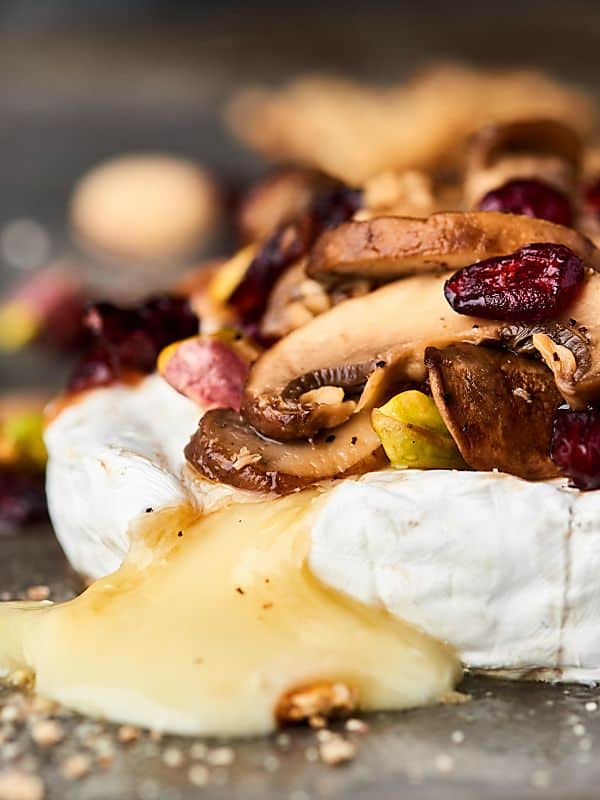 #ad The BEST appetizer yet, this Mushroom Brut Brie is totally impressive, ridiculously easy, and ultra cheesy! Melty brie is topped with brut champagne, buttery mushrooms, and crunchy pistachios! showmetheyummy.com Made in partnership w/ @barefootwine #mushrooms #brie