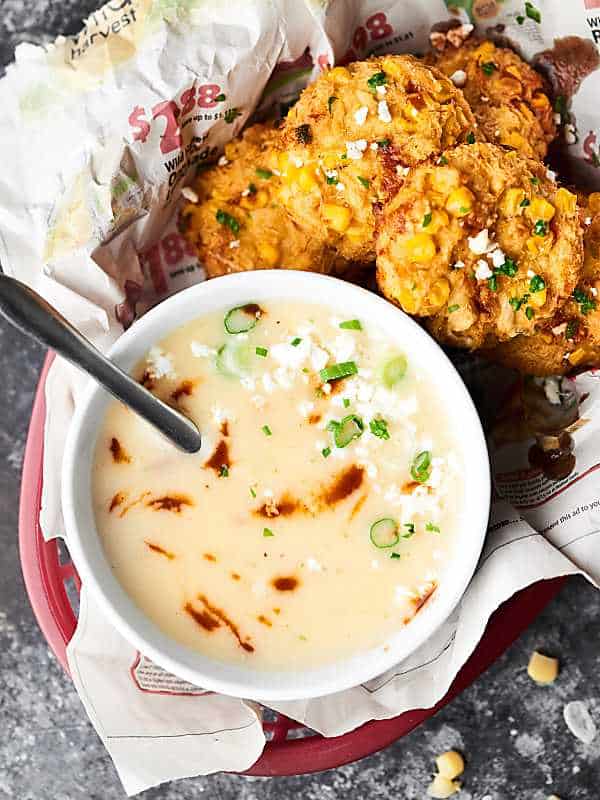 baked corn crab cakes in basket next to bowl of soup above
