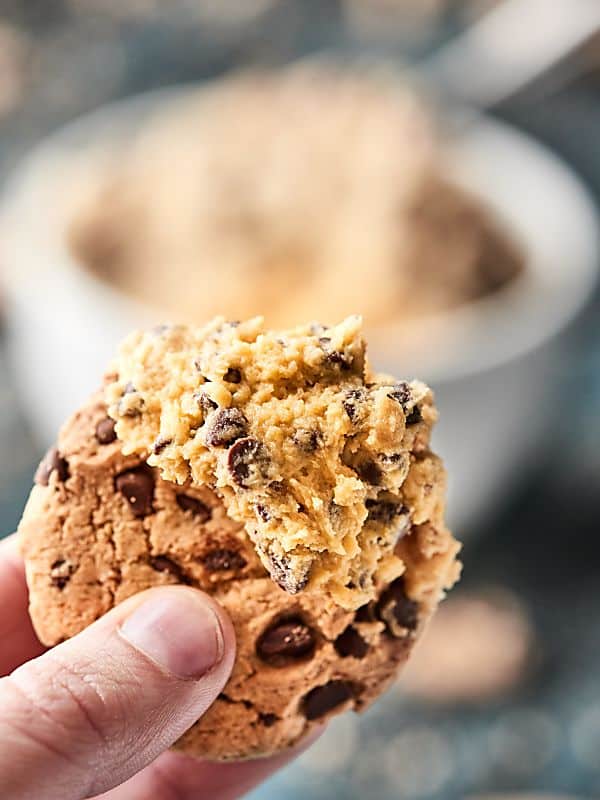 chocolate chip cookie dough dip on chocolate chip cookie held