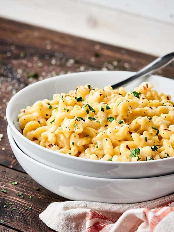 Five ingredient mac and cheese in bowl with spoon side view