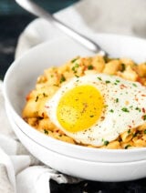 #ad This Breakfast Mac and Cheese Recipe is made in ONE pot and is loaded with THREE kinds of cheese, spicy breakfast sausage, and potatoes, and topped with a runny egg! showmetheyummy.com Made in partnership w/ @crystalfarms #cheeselove #CrystalFarmsCheese