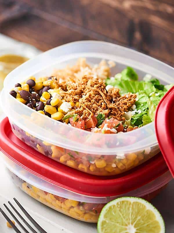This Chicken Burrito Bowl Recipe is perfect for meal prep! They're quick and easy to make, healthy, gluten free, and loaded with crockpot chicken, beans, corn, a tangy dressing, and more! showmetheyummy.com