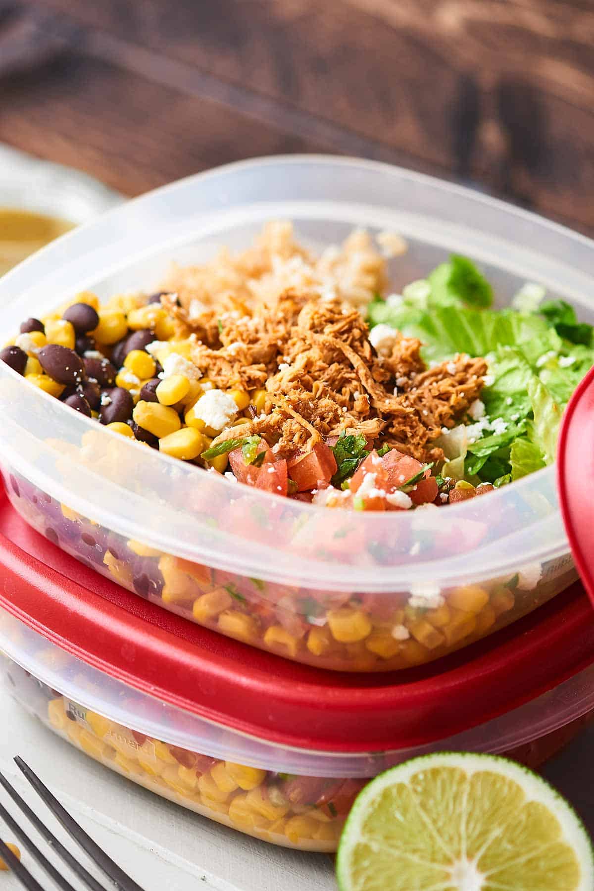 This Chicken Burrito Bowl Recipe is perfect for meal prep! They're quick and easy to make, healthy, gluten free, and loaded with crockpot chicken, beans, corn, a tangy dressing, and more! showmetheyummy.com #burritobowl #mealprep #chicken