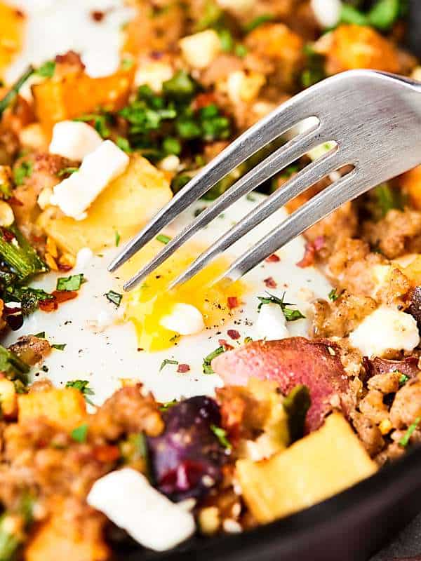 sausage and potato breakfast hash with fork closeup