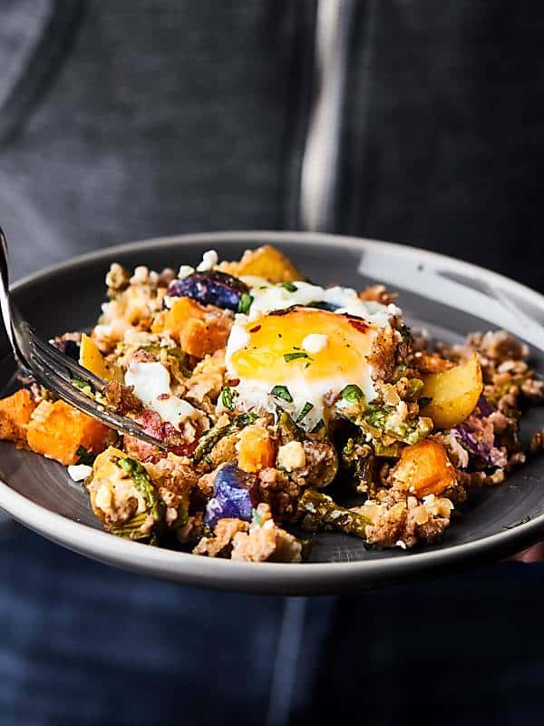 breakfast hash on plate held