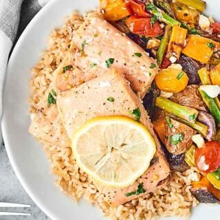 This Sheet Pan Spring Salmon and Veggies Recipe is healthy, easy cooking at it's finest! Salmon, potatoes, asparagus, and tomatoes are roasted with a light lemon, garlic, dijon dressing! showmetheyummy.com