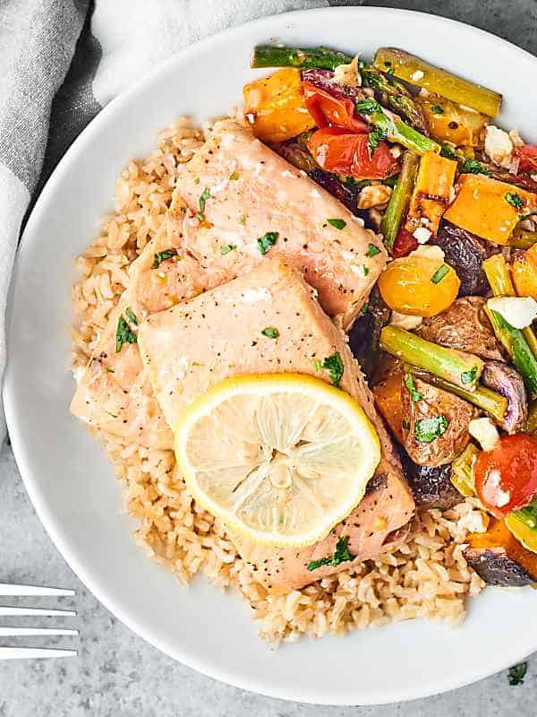 sheet pan spring salmon and veggies on plate above