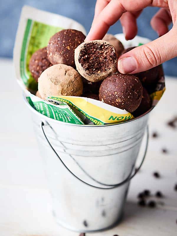 tin can of protein brownies bites, one being taken out