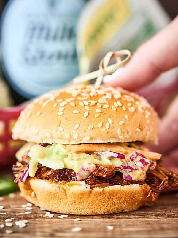 This Instant Pot BBQ Pulled Pork Recipe comes together in a matter of minutes and cooks in only 90 minutes! A quick, easy, pretty darn healthy weeknight dinner that's packed with tender pork and a tangy homemade BBQ sauce! showmetheyummy.com