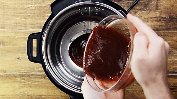 BBQ sauce being poured into instant pot