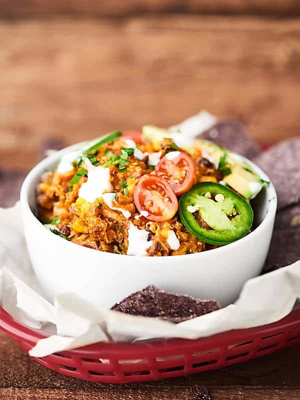 bowl of slow cooker enchilada quinoa in basket with chips