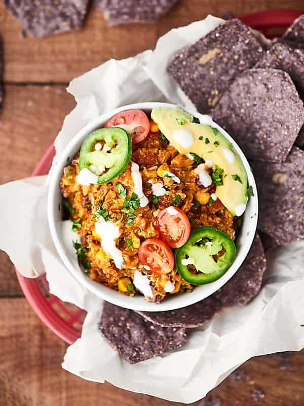 bowl of enchilada quinoa with basket of chips above