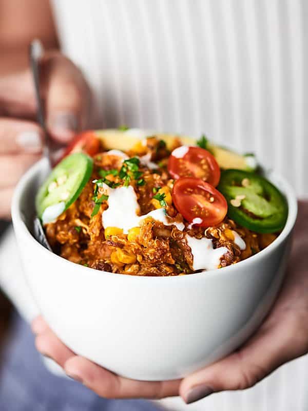 bowl of slow cooker enchilada quinoa held