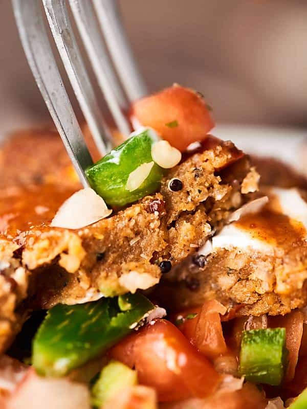 bite of enchilada bowl being picked up with fork closeup