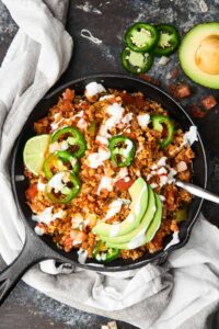 This Taco Cauliflower Rice Skillet is quick, easy, healthy, low carb, and absolutely delicious! Loaded with ground turkey or chicken, vegetables, and frozen cauliflower rice! showmetheyummy.com