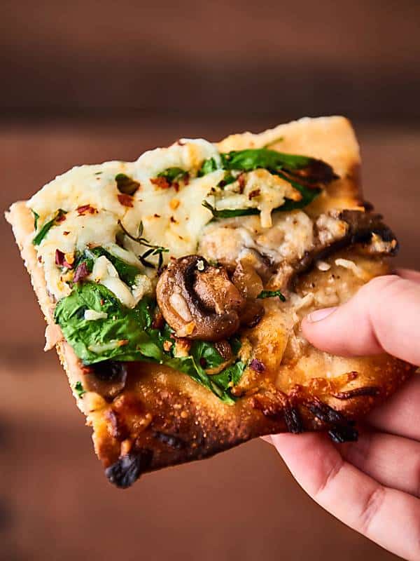 #ad Caramelized Onion and Mushroom Pizza. Thin crust topped with onions, mushrooms, spinach, tons of cheese, and a little thyme! showmetheyummy.com Made in partnership w/ @Pillsbury #Pillsbury