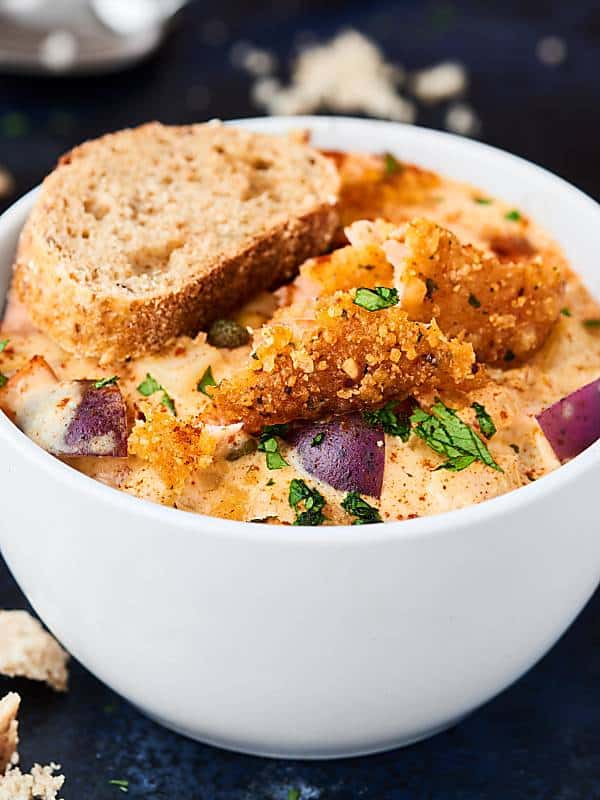 bowl of chipotle salmon chowder with slice of bread
