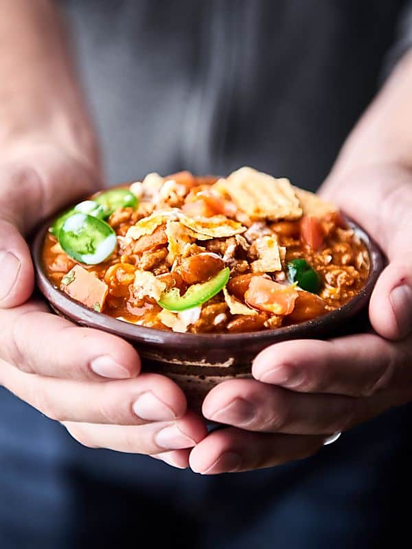 Bowl of beef chili held