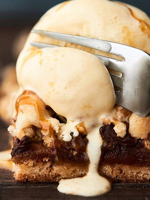 granola cookie bar with ice cream being cut with fork