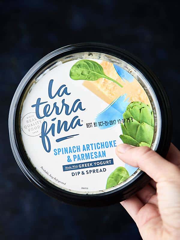 spinach and artichoke greek yogurt spread container held