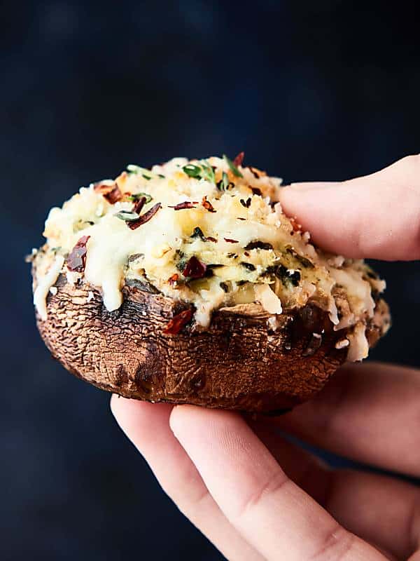 spinach artichoke stuffed mushroom held