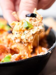 This Loaded Pizza Dip is like supreme pizza in dip form! A cream cheese base topped with sausage, veggies, pizza sauce, pepperoni, and loads of cheese! Easy game day appetizer or snack! showmetheyummy.com