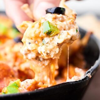 This Loaded Pizza Dip is like supreme pizza in dip form! A cream cheese base topped with sausage, veggies, pizza sauce, pepperoni, and loads of cheese! Easy game day appetizer or snack! showmetheyummy.com