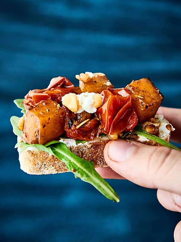 Roasted Butternut Squash Bruschetta. Chewy baguette topped with goat cheese, arugula, roasted butternut squash and tomatoes! showmetheyummy.com