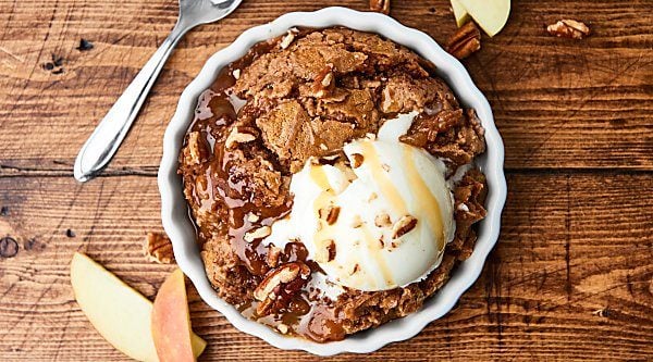 This Slow Cooker Caramel Apple Dump Cake Recipe might be my easiest recipe yet! Only 5 ingredients: apple pie filling, pecans, caramel, spice cake mix, and butter! showmetheyummy.com