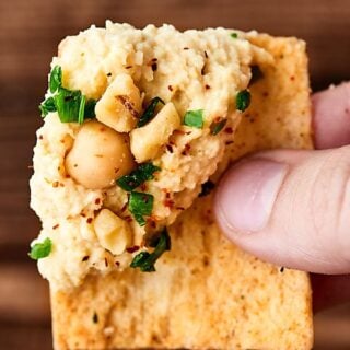 This Syrian Hummus Recipe is simple to make and packed with flavor! Full of chickpeas, lemon, tahini, and garlic, it's so delicious and ultra creamy! showmetheyummy.com