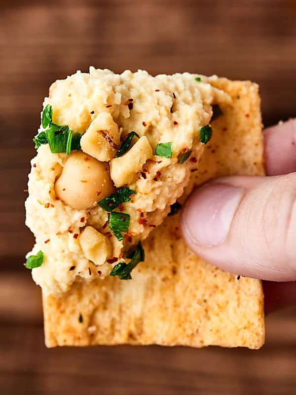 syrian hummus on cracker held