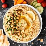 This Syrian Hummus Recipe is simple to make and packed with flavor! Full of chickpeas, lemon, tahini, and garlic, it's so delicious and ultra creamy! showmetheyummy.com
