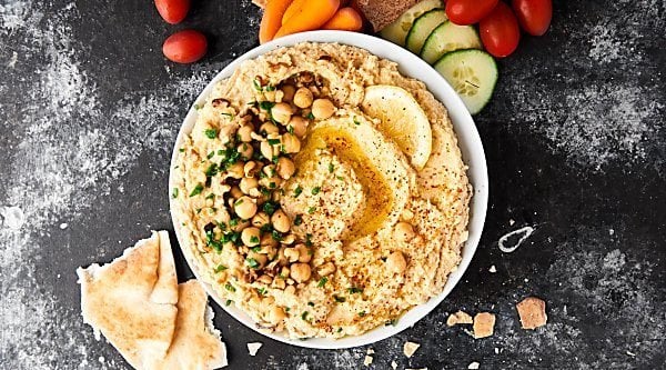 This Syrian Hummus Recipe is simple to make and packed with flavor! Full of chickpeas, lemon, tahini, and garlic, it's so delicious and ultra creamy! showmetheyummy.com